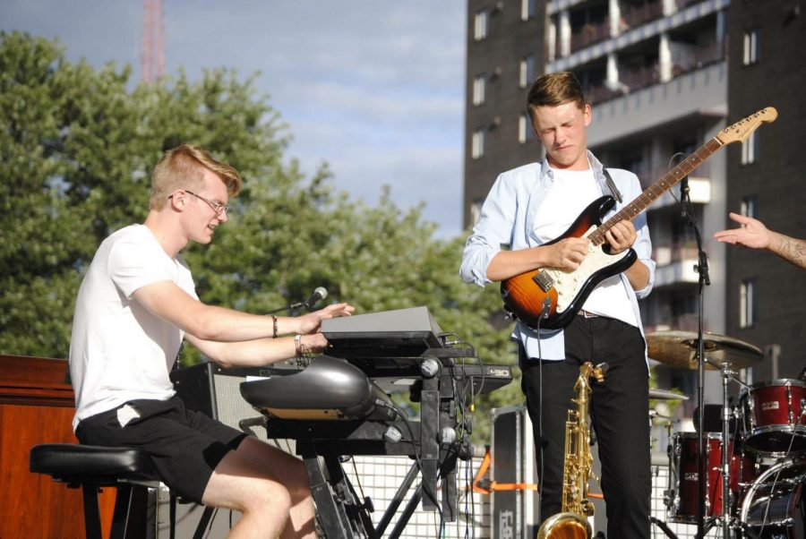 “I just had my eyes closed a lot more,” Neumayer (right) said, as he played with his band in front of thousands of listeners at Midtown Crossings. 