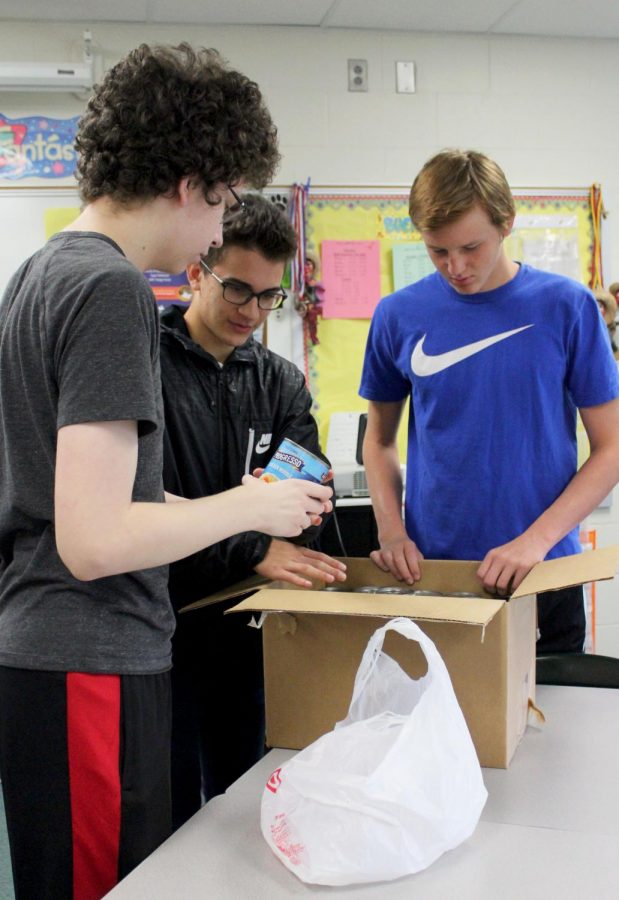 Josh Ratliff spends time during second block packing boxes of donated items. 