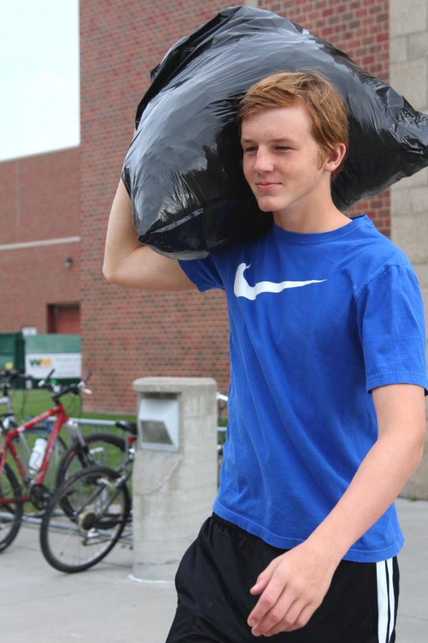 Wade Ott contributes to loading the goods into the pick-up by carrying bags outside.