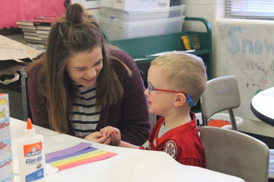 Senior Tess Ray works with students during the Education Academys Toddler Day. This annual event helped Academy students plan activities for future careers in education.