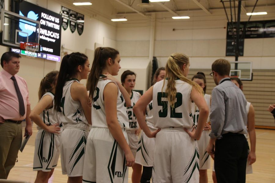 The JV Lady Cats huddle it up at halftime. Photo by Andrew Pfeifer.  