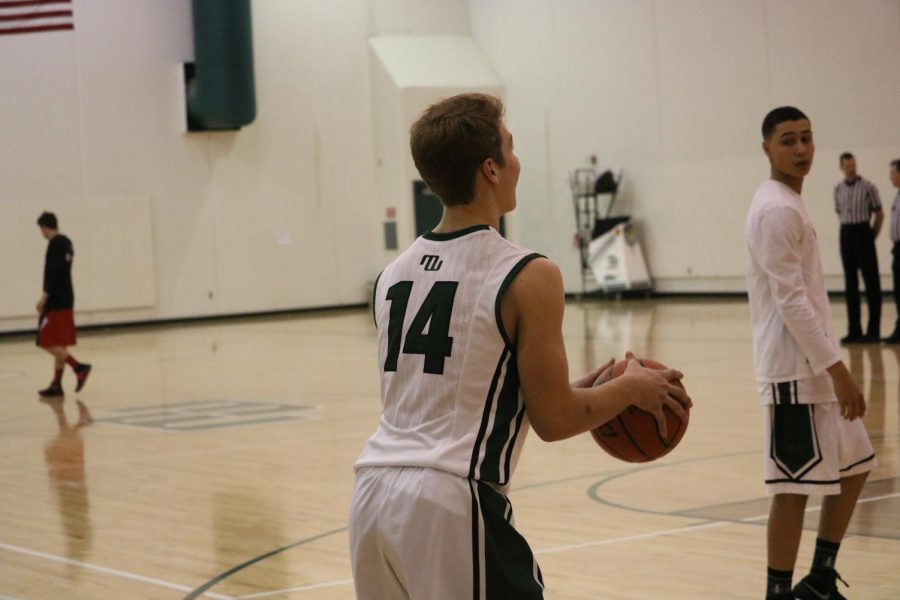 Sophomore Trey Wilbeck shooting a three before the game 