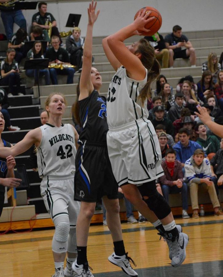 Going up for the shot, senior Courtney Merryweather floats in the air. She wore a brace throughout her season to make sure another injury wouldnt happen. 