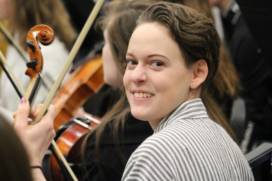 Natalie Brauer smiles in orchestra.