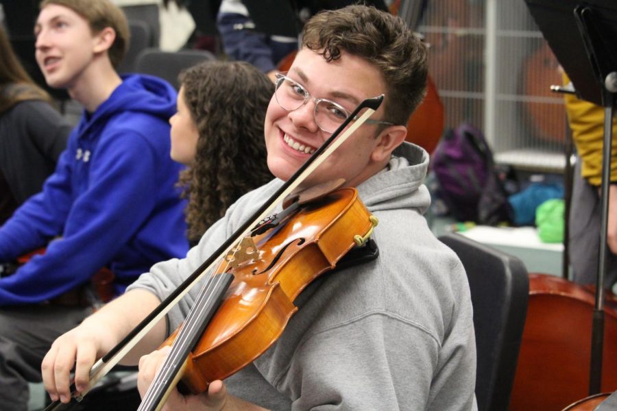 Nicholas Thier happily plays his instrument.