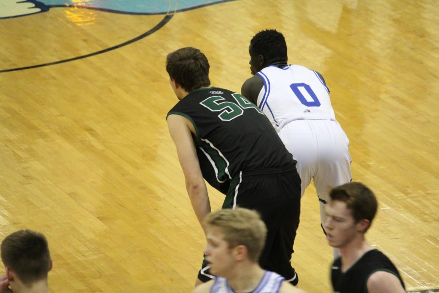 Brock Burling and a Creighton Prep player wait for the ball.