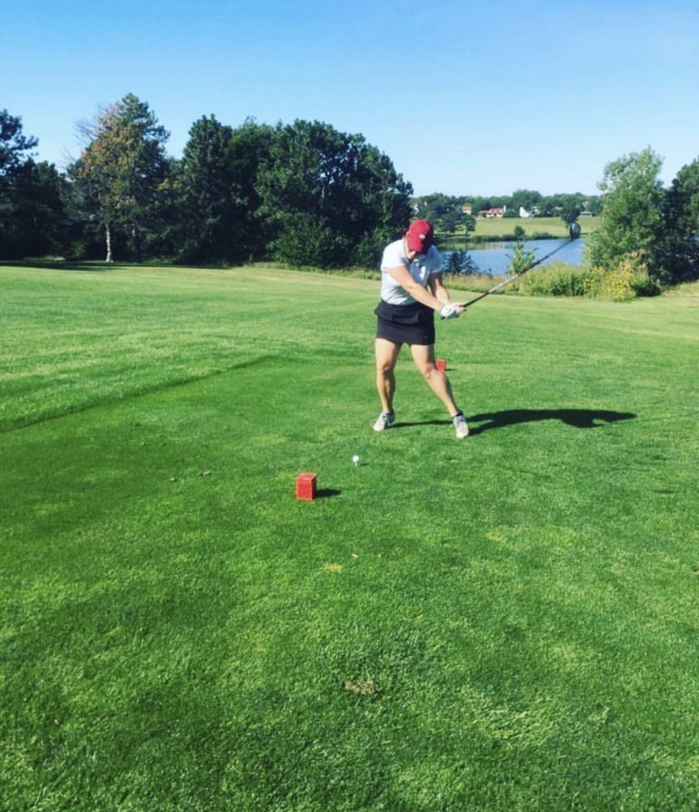 Izzabelle Puk swinging her club.