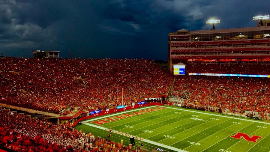 Husker+fans+wave+their+phone+flashlights+with+the+beat+of+the+music+while+waiting+out+the+weather+delay.