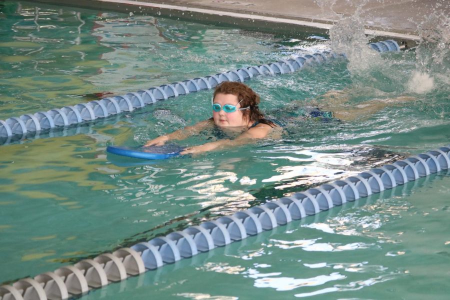 Swimming down the lane, junior Nathalie Ollerich competes in Unified Swimming. The students have been practicing in the evenings to prepare for competitions. I have a blue ribbon from my swimming race already, Ollerich said. 