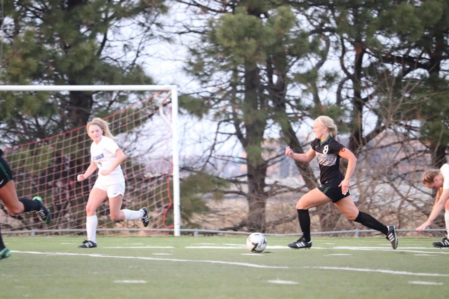 Junior Reagan Raabe dribbles down the field in the second half against Millard North. She scored in their 6-2 win. 
