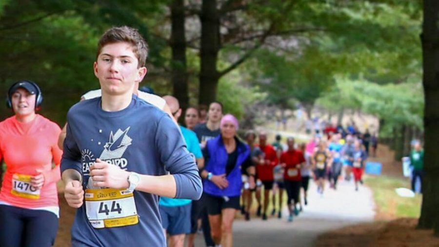 Sophomore Evan Vaslow flies by as he works through the race.  Vaslow is pictured here about half way through the race, right at about the five mile mark.  “The race was a challenge,” Vaslow said.  “But I was able to push through it and take it down.”
