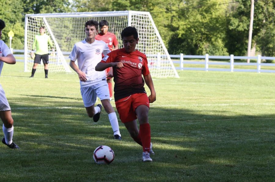 Feeling focused, junior Nasser Nabulsi gets to the ball to kick to his teammate in a game of soccer. He played for the Nebraska futbol club against the team Scott Gallagher from Kentucky. Playing other teams from different states is really cool so I can see how everyone plays different. Nabulsi said. it also helps me improve for every game.