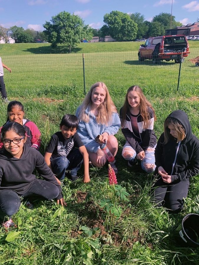This is a picture of elementary schoolers planting a garden with the help of Hailey Reavis. They started planting in a field near the Henry Doorly Zoo. “We took an empty field and turned it into a garden and  home for insects,” Reavis said. “While doing that we also taught some younger kids about the importance of the environment and planting seeds.”
