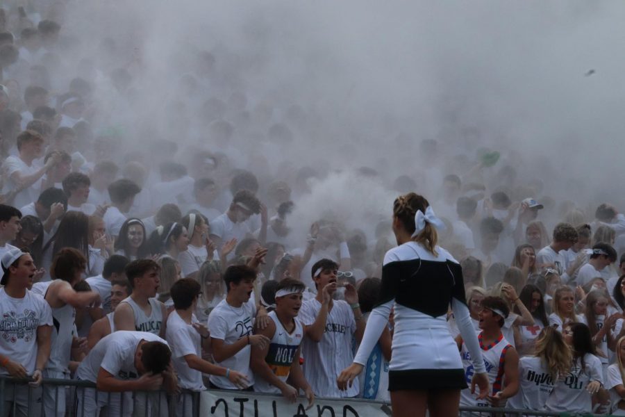 Student section throwing powder into the air 