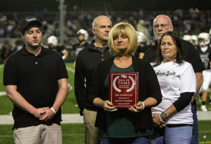 Patty Johnston accepts the Hall of Fame plaque for her husband Jim Johnston who passed away in 2014. She was a part of the special ceremony held at half time of this year’s football game. “This means a lot,” Johnston said. “He is still remembered and people are thankful for what he did for the community and for Millard West.”