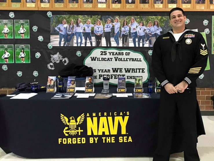 Petty Officer Dustan Skorcz stands in front of the student body at lunch ready to spread the Navy word.
