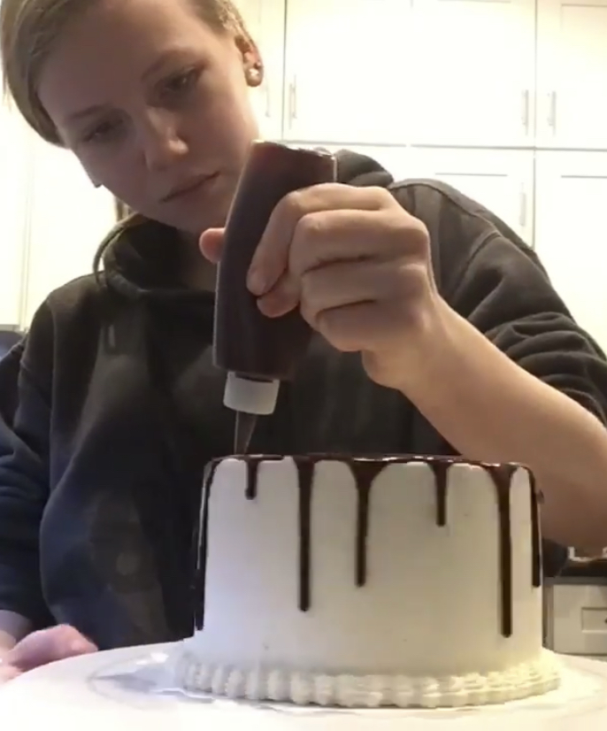 When in the kitchen, freshman Edison Gilbert uses a lot of decorating techniques to elevate her cakes. One of her favorites, includes using the drip technique to emphasize the otherwise basic design. By using this bottle, Gilbert can control the topping and decide where she would like the drips to fall on the cake but the process to get here does take some time. Each cake I make usually takes about two days to make completely, Gilbert said. I like to make the cakes a day prior and then decorate them the next day. I’m a really impatient person and don’t like to wait for the cakes to cool down and would rather just do it all in the same day.