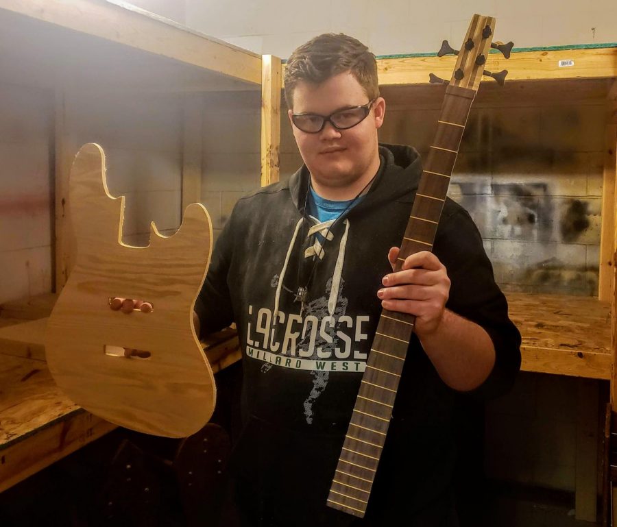 Photo of senior Owen Berreth holding the neck of his guitar							And the prototype for the guitar body working to make sure the final version is correct. “ We had to Make a prototype of the final body to make sure Everything was right because it's something that You only get one chance,” Berreth said. “And I can always use The prototype as just 
something cool to put on my wall once I’m done.”
