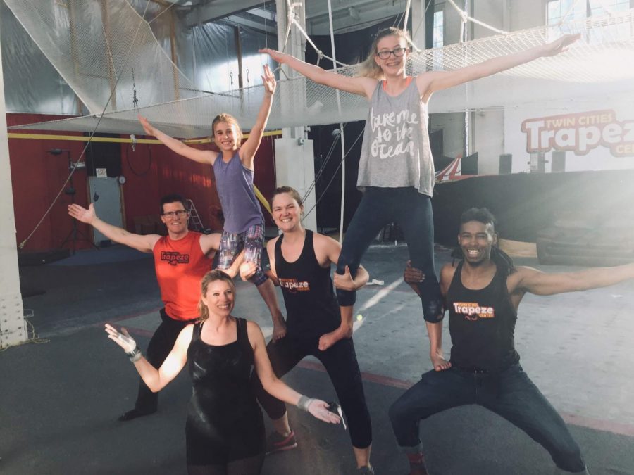 Sophomore Adison Mullenburg (top right) poses with other trapeze fliers with a bright smile. Being involved in physical activities such as fencing and trapeze has created an outlet for Mullenburg. “They’re both an escape for me, I don’t think about anything while flying,” Mullenburg said. “I think of nothing during fencing other than what my next move isx and how my opponent is moving.”
