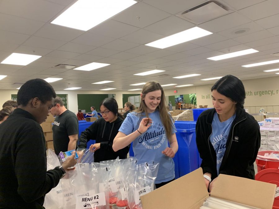 Members of National Honors Society pack bags with fruit and juice at Food Bank for the Heartland to be donated to families. “Whenever I have time I always try to do things like this because I really enjoy helping people,” junior Jordan Bakar said. “It was fun engaging with people and working with others to help out the community.”
