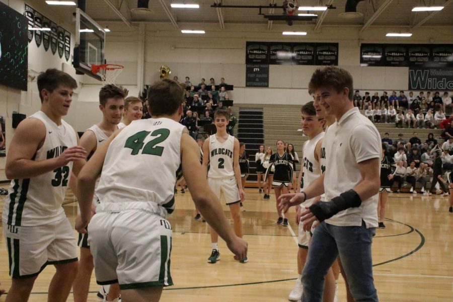 The Wildcats hype up their teammates before they take the court. Conway (42) ran through his teammates tunnel onto the court before the game. The Wildcats have great team chemistry and work well as a group and that leads to a successful turnout on the court.