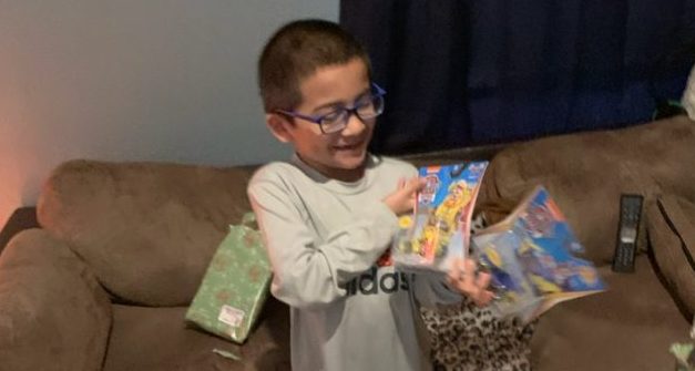 Pictured above is one of the children receiving his gifts from the Honors Spanish 4 class