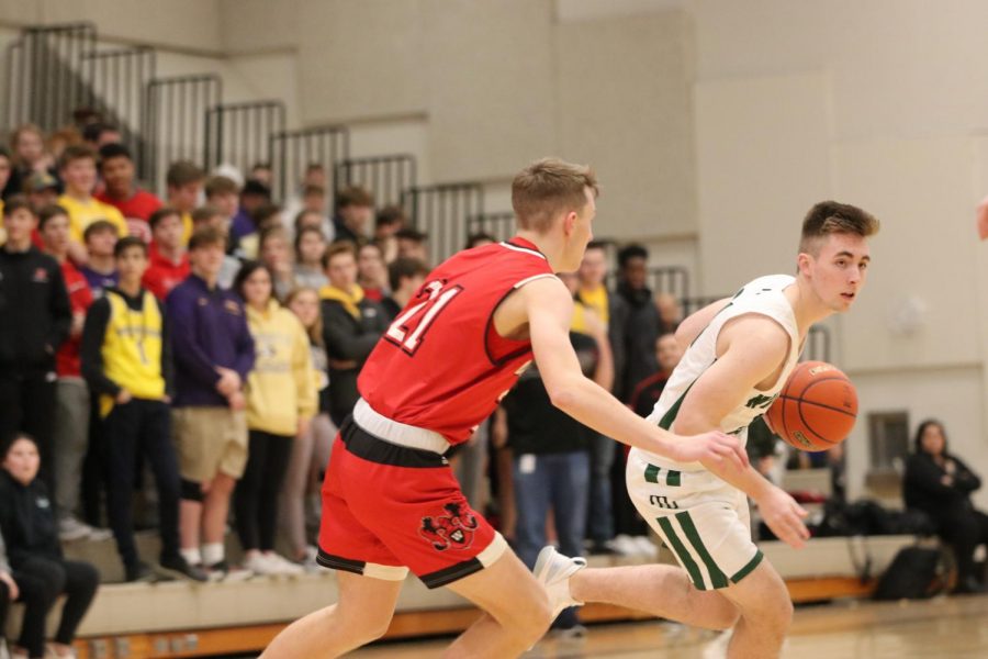 Senior Henry Polsley gets the ball and dribbles past the Westside Warriors. 