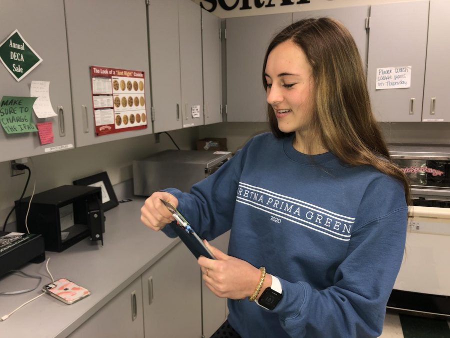 Junior Elise Nyffeler works in the Scratching Post as a part of DECA. She is a junior officer and is in there during her lunch period for students to shop.