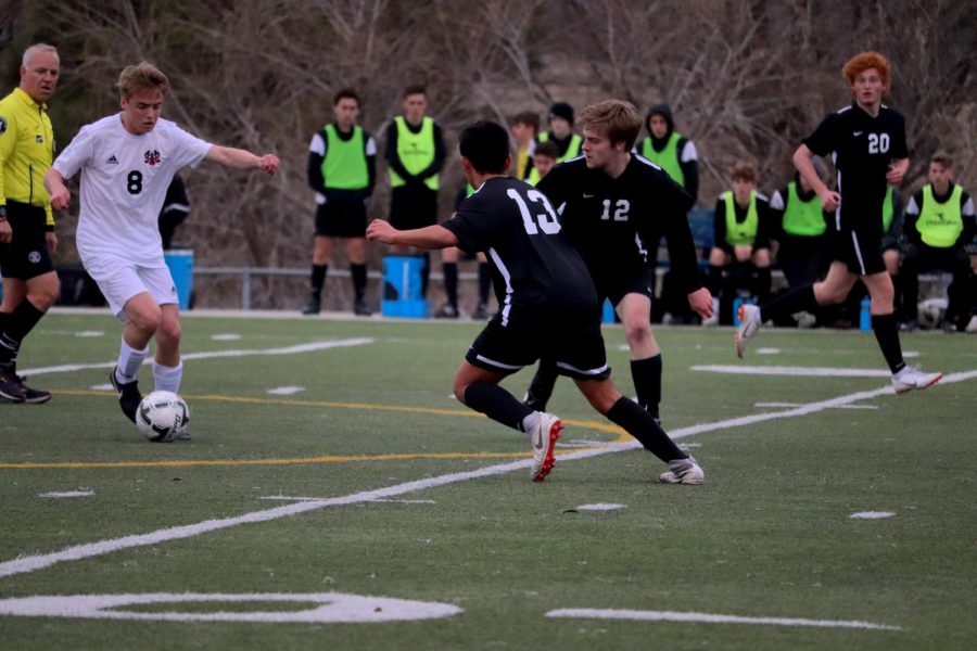 Junior, Nasser Nabulsi defends the Westside Warriors from the goal by trying to reverse the ball with the help of midfielder alum Trevor Green. 