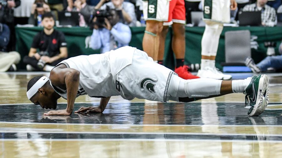 Michigan State senior guard Cassius Winston kisses the floor after checking out on senior day, a Spartan tradition, during their game against the Ohio State Buckeyes. Little did Winston know this would be his last time on the floor wearing a Spartans uniform.