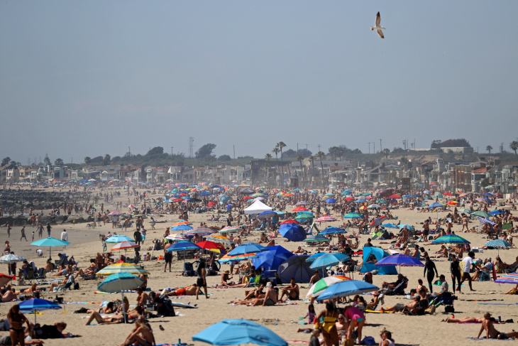 Huntington beach is packed with vacationers, April 25, 2020. Not a single mask in sight, nor was social distancing considered.