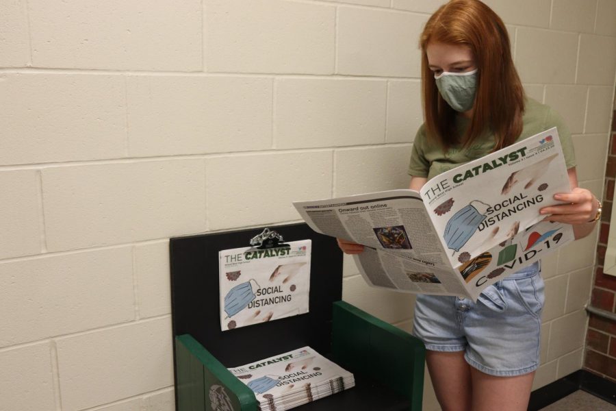Millard West senior and CATalyst Editor-in-chief Emma Baker grabs a paper from the stand. She was very excited to see her work on the stands. “It makes me proud to see that all of our hard work in making this paper can be displayed for all of the students to see,” Baker said. “Hopefully this will encourage more people to pick up a paper to read.”
