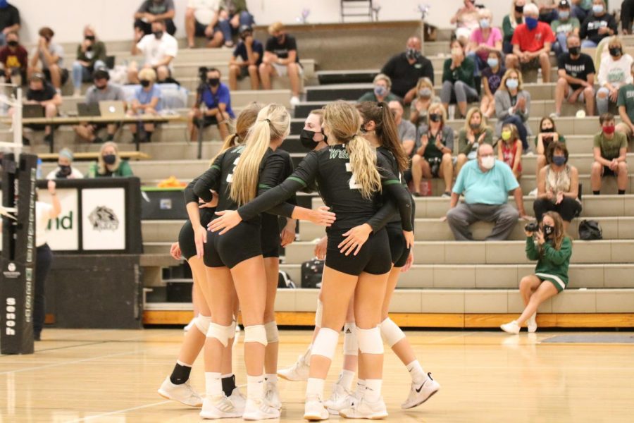 Millard West volleyball members celebrating during a match against Millard South. The Wildcats won this match in a sweep over the Patriots. “We’ve had some ups and downs this year but we are all very close and have a really great culture throughout the team,” senior Bridget Smith said. “We always find a way to push through a tough match and we learn from each game.”