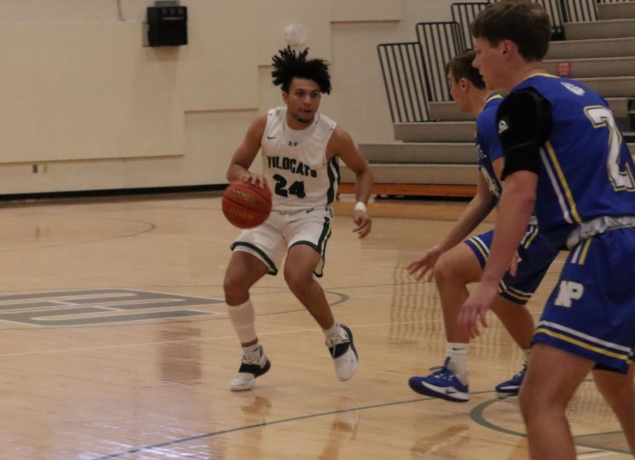 Senior+Wildcat+guard+Dominic+Humm+sets+up+for+an+offensive+play+against+the+North+Platte+Bulldogs.+Humm+finished+the+weekend+with+43+points%2C+averaging+21.5+through+the+first+two+games.+Humm+looks+like+one+of+the+more+potent+offensive+threats+in+the+metro.+