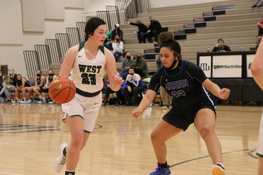 Senior Reese Peterson of Millard West being guarded by senior Aryannah Harrison of Marian. The game was a very defensive match with a lot of fouls and turnovers. “We knew going into the game that Marian had two really good players who have found many different ways to score so we had to keep them under control,” Peterson said. “Our game plan was to kind of make the rest of the team beat us.” 