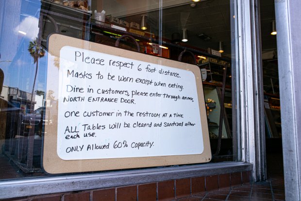 Owners put our signs on their restaurants for incoming customers to follow in order to be safe. (Photo by David Crane)