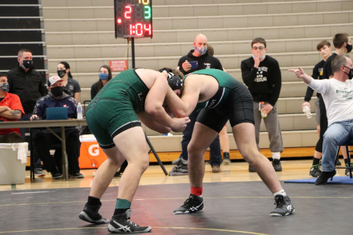 Nosal (left) is pictured wrestling his round two opponent Blake Baker (right). “Overall the team did alright,” Nosal said. “We had some issues, one of our studs missed weight, and some of the younger kids gave up pins they can’t. Other than that, we did pretty well.”