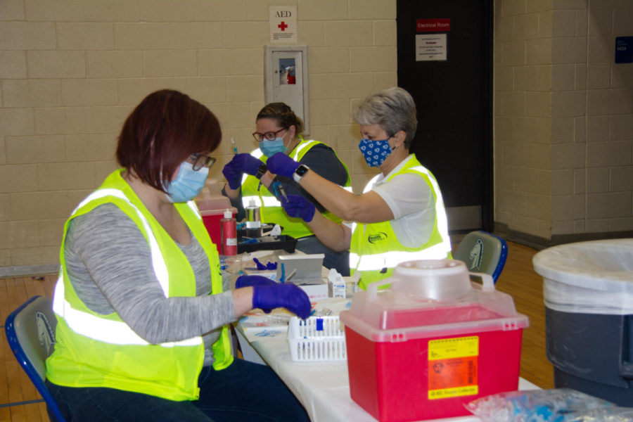 Nurses prepare to distribute vaccines at Millard North High School. In the last couple of weeks, thousands of school educators and staff have been vaccinated at weekend clinics. 