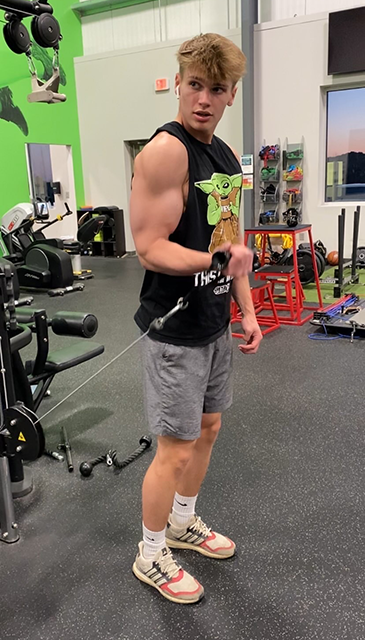 Senior Hunter Strong working on his biceps while taking pictures to post on his gym account, HunterStrong.fit.  “I like to post as much as I can to grow my page and following.”

