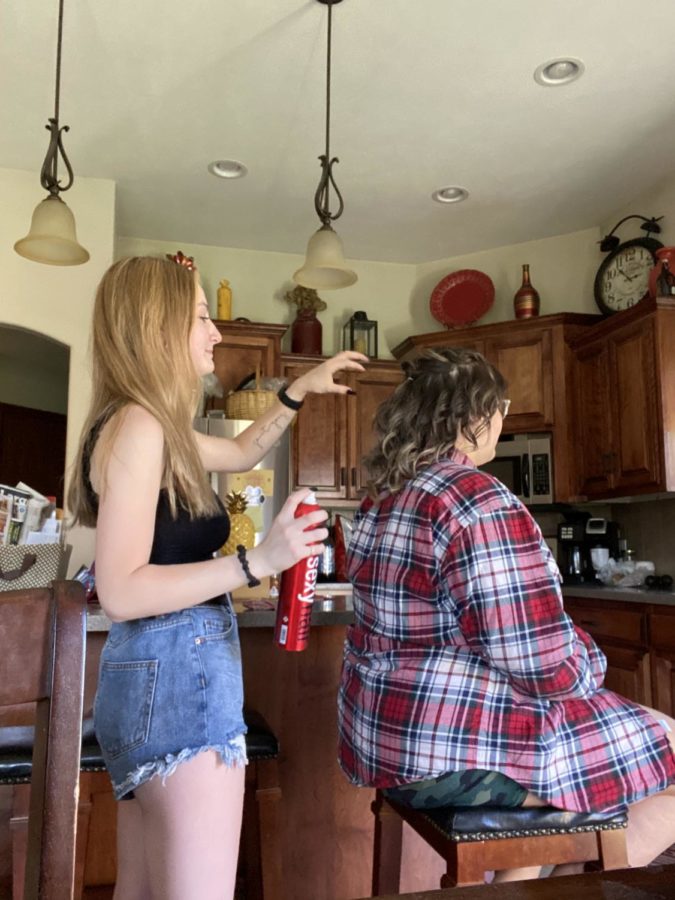 Senior Milina Mike styles hair for a prom event. “I grew up with cosmetology surrounding me constantly,” Mike said. “My parents have prepared me my whole life. I’ve learned a lot of technique and I have shadowed multiple students at the school to get an idea of what life will be like while I’m there.” 	