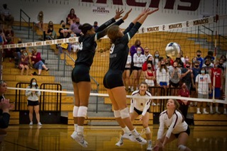 Junior Alanna Bankston and sophomore Lauren Jones complete a block in the match against Papillion-La Vista. Jones and Bankston led the team with one block each. “We are always so upbeat when we get ready to play,” Bankston said. “The atmosphere with both of the student sections was fun to play in, and the fans really helped us keep our energy going throughout the match.” 