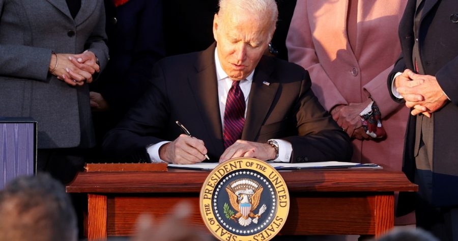 The infrastructure bill being signed into affect by president Joe Biden. This bill is said to be a community bill, which will use money which wasnt used during COVID relief. The controversy over this infrastructure bill is large, with communities taking both sides towards it. 
