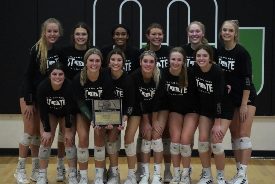 The+varsity+volleyball+team+poses+for+a+picture+with+the+district+championship+trophy+after+their+sweep+of+Millard+North.+The+Wildcats+swept+their+way+through+Districts%2C+advancing+to+the+state+tournament.+%E2%80%9CI+am+a+bit+nervous+for+state%2C+but+my+mindset+going+in+is+to+just+have+fun%2C%E2%80%9D+senior+Sadie+Millard+said.+%E2%80%9CIt%E2%80%99s+my+last+time+playing+volleyball+for+Millard+West+and+is+going+to+be+the+end+of+my+volleyball+career+overall%2C+so+no+matter+the+outcome+I+want+to+have+the+time+of+my+life+on+the+court.%E2%80%9D%0A
