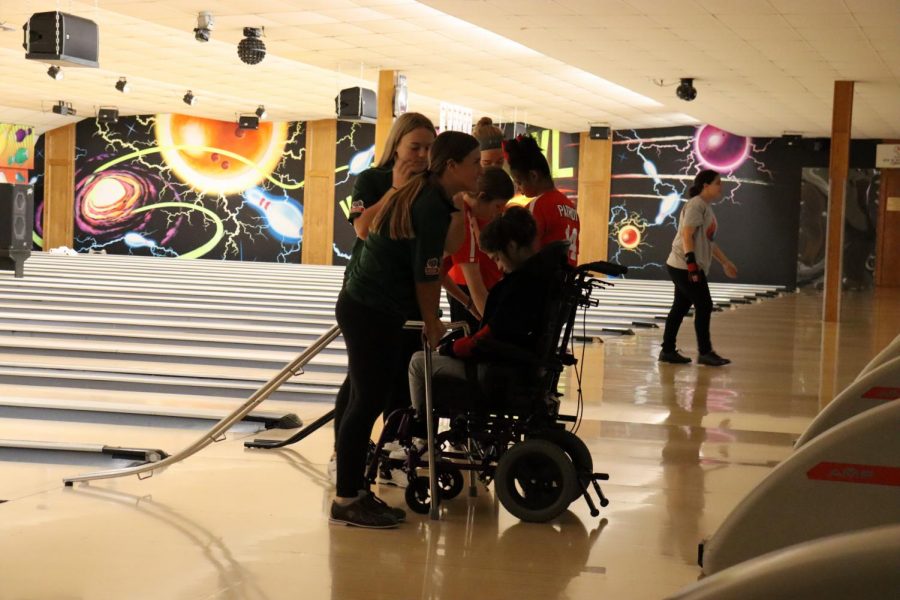 Keeping the ramp sturdy, junior Jayci Reimers helps her teammate Addison Scott roll her bowling ball down a lane at the Millard Invite. Participating in several Unified sports before Reimers was looking to expand her relationships with her fellow teammates. “You get the privilege to work with kids that help you learn more life skills that you can use in the future,” Reimers said. “I am so happy I chose to join Unified Bowing because everyday and every minute you spend with these kids you are learning so many new things and making so many memories.”