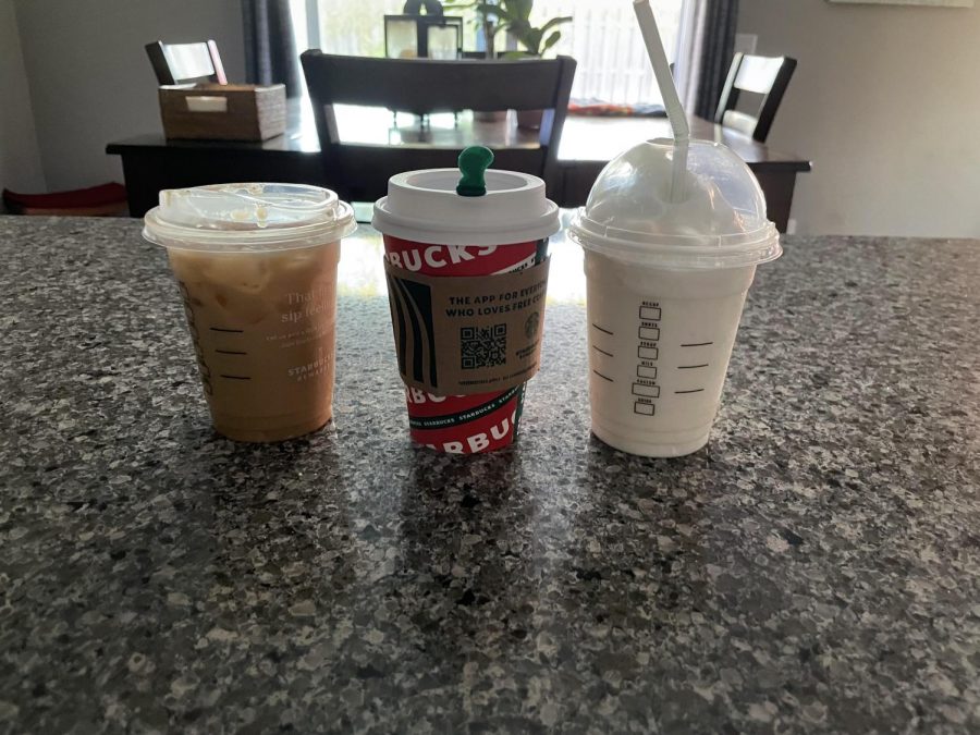 These are the three seasonal drinks that came out on the Starbucks menu., In the middle is the toasted white chocolate mocha, on the left is the ice sugar cookie almond milk latte and on the right is the Caramel Brûlée Latte.
