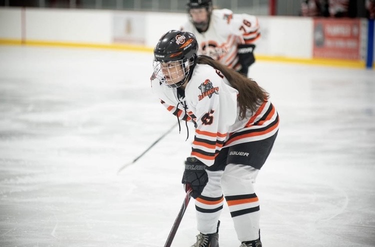 While battling it out on the ice, senior Brooke Flanigan plays a game for the Lady Jr. Lancers U19 team. Flanigan has to focus on many different aspects of the game as a left-wing. “The most challenging part of hockey is that there is so much going on and how fast it is moving,” Flanigan said. “You have to think about where the puck is, who is open, who you have to cover, where the open person is and what to do when you have the puck and what to do when you dont have the puck.” 