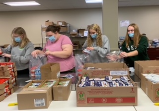 Seniors Carly Finch, Charlotte Kittle, Bella Delgadillo and Brenna Matthews package food for the Backpack Program. Eight hundred fifty kids were able to have food over the weekend, thanks to the students’ generosity. “I learned how to be fast and efficient and make the best of the time we had there,” Delgadillo said. “I felt good we made over 800 packages of food, so it was good to know we could give so many people food and help them.”