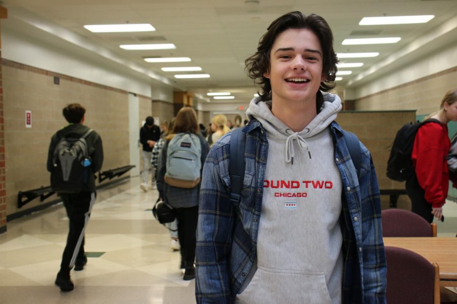 Senior Nathanael Ray smiles brightly as he participates in flannel day for holiday spirit week.