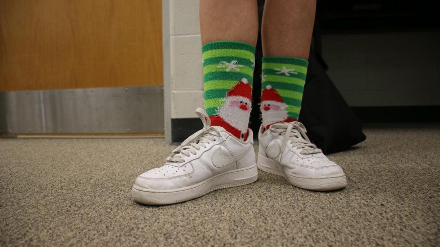 Dressed in Santa socks, sophmore and journalism staff member Sadie Smith takes on sock day.