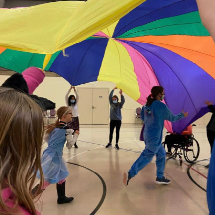 Two members got to run under the parachute near the end of the session. There is music playing and volunteers direct the members on how to move the parachute. “I’ve loved Special Musicians because it provides another opportunity for expression for people with intellectual disabilities,” volunteer Sophia Hill said. 
